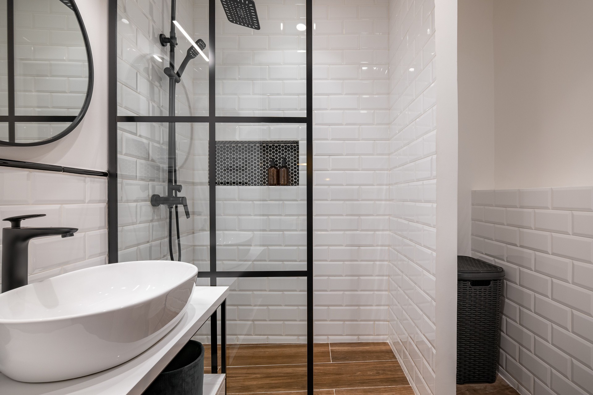 Modernes Badezimmer mit Glasdusche und weißen Fliesenwänden